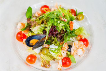 Seafood salad with vegetables on a white background