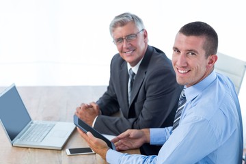 Businessmen working together with laptop and tablet