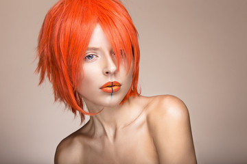 Beautiful girl in an orange wig cosplay style with bright creative lips. Art beauty image. Portrait shot in the studio. - obrazy, fototapety, plakaty