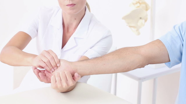 Doctor massaging patients hand