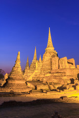 Fototapeta premium Asian religious architecture. Ancient pagoda at Wat Phra Sri Sanphet temple under twilight sky. Ayutthaya, Thailand