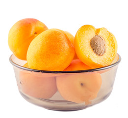 Yellow apricots in a transparent bowl