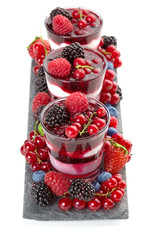 glasses with frozen dessert with berries on a tray slate