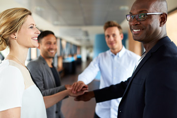 Group of young executives smiling before teamwork