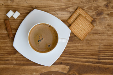 Hot cup of coffee on sack with cookies