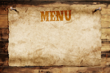 old menu card nailed on a wooden wall