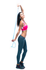Smiling fitness woman holding skipping rope