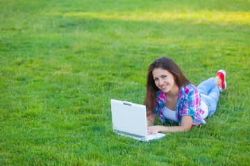 Young teen girl with white laptop computer