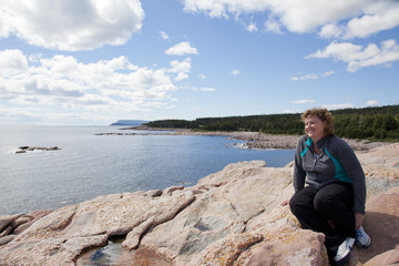 Fototapeta na wymiar Woman relaxing at Green Cove Cape Breton