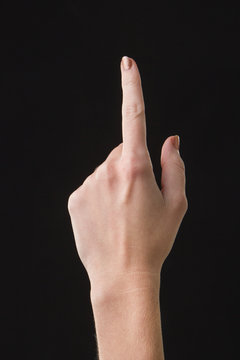 Finger on a touchscreen isolated with dark background