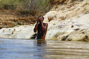 Man showering in the river