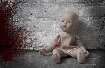 Concept of child abuse - Bloody doll