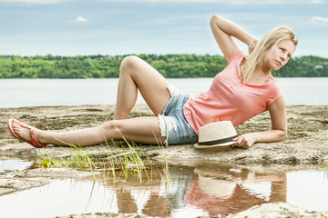 Fototapeta na wymiar Woman lay on beach with hat