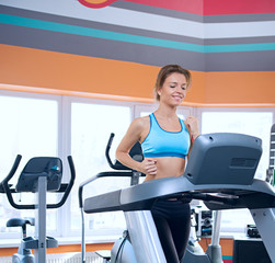 Fototapeta premium beautiful woman runs on a treadmill