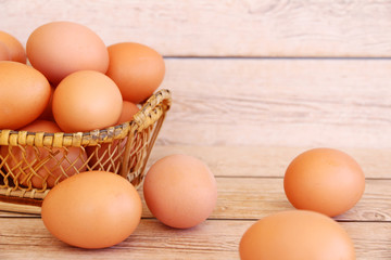 Eggs in the basket on wooden background