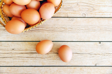 Eggs in the basket on wooden background