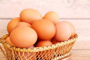 Eggs in the basket on wooden background