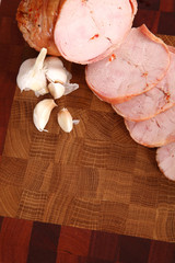 Ham slices on a wooden chopping board