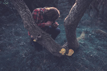 Photographer taking a photo of a fungus