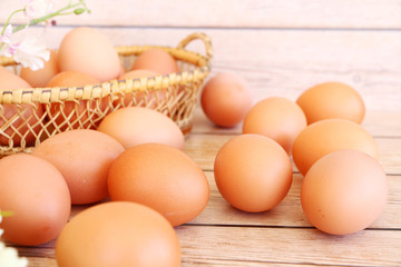 Eggs in the basket on wooden background