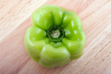 Green paper on a wooden board