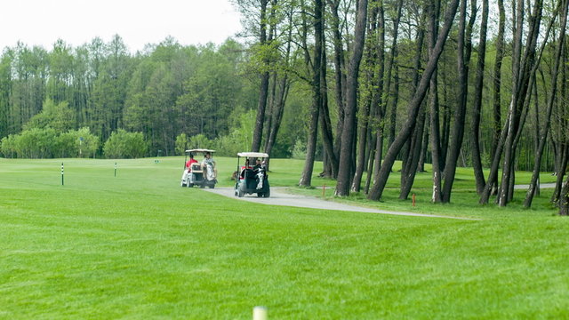 Golf cars moving on field