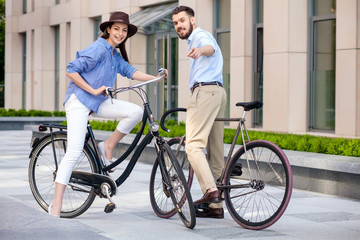 Romantic date of young couple on bicycles