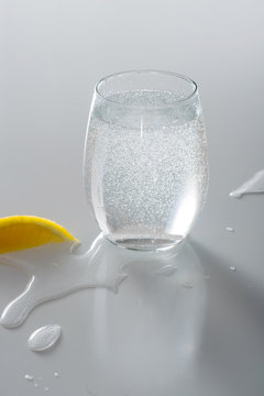 Sparkling Water in Glass with Spilled Water