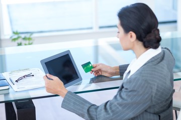 Businesswoman doing online shopping in office