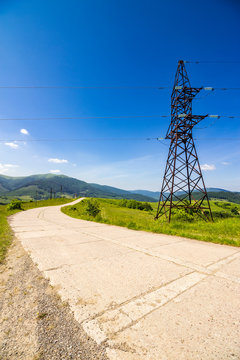 High voltage power lines tower in mountains
