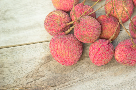 fresh lychees on wooden background