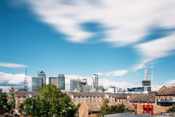 Long exposure cityscape of Canary Wharf / London Financial District viewed from Isle of Dogs on a sunny day