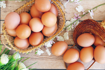 Eggs in the basket on wooden background