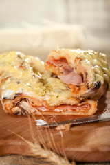 Calzone -  italian closed pizza stuffed with cheese and ham