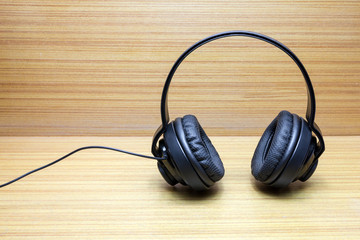 Headphones on wood background