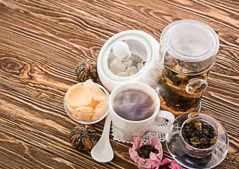Tea cups with teapot on old wooden table
