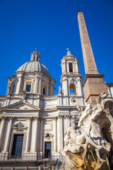 Fototapeta na wymiar Four River fountain by Bernini, egiptian obelisk, and Santa Susanna Church in Navona Square in Rome