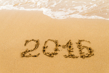  2016 Yearwritten on  sand,  tropical beach. Selective focus.