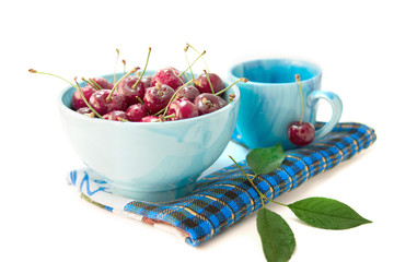Cherries in blue tableware. Healthy eating.
