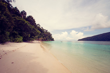 Beautiful sea and sand beach in Andaman sea, Thailand. Retro filter.