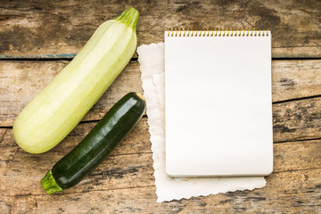 Menu background. Vegetables on table with cook book. Cooking with recipe book.