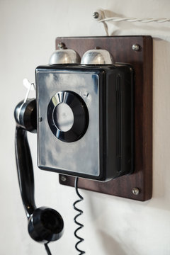 Vintage black wired phone on the wall