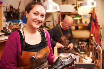 Shoemakers working in a workshop, portrait