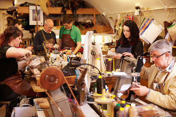 Shoemakers working in a busy workshop