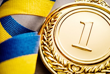 Gold medal on a dark blue background