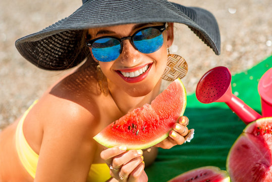 Woman Eating Watermelon On The Beach