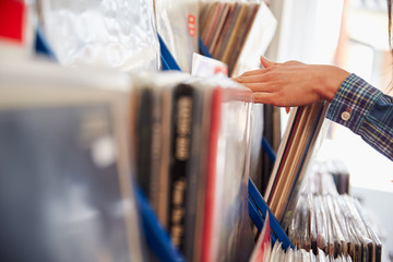Detail of hands browsing records at a record shop