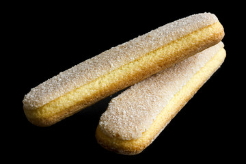 Savoiardi italian sponge biscuits isolated on black.