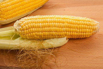Sweetcorn on wooden table