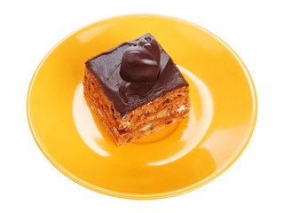 Chocolate cake on orange plate